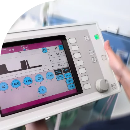 A nurse is using a machine to monitor a patient with custom label solutions.