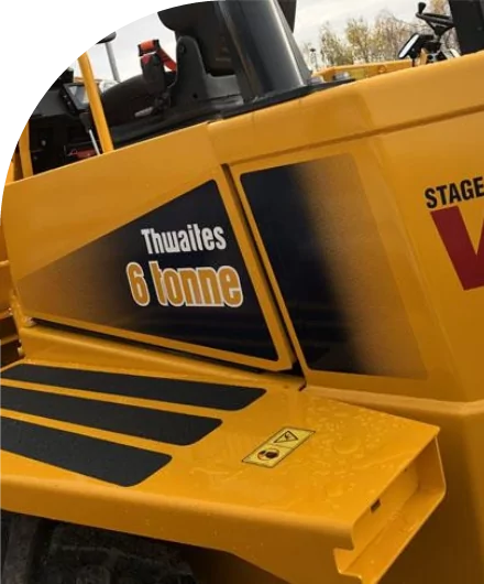 A bulldozer with high quality labels is parked in a parking lot.