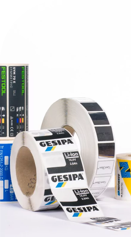 A variety of labels and decals on a white surface.