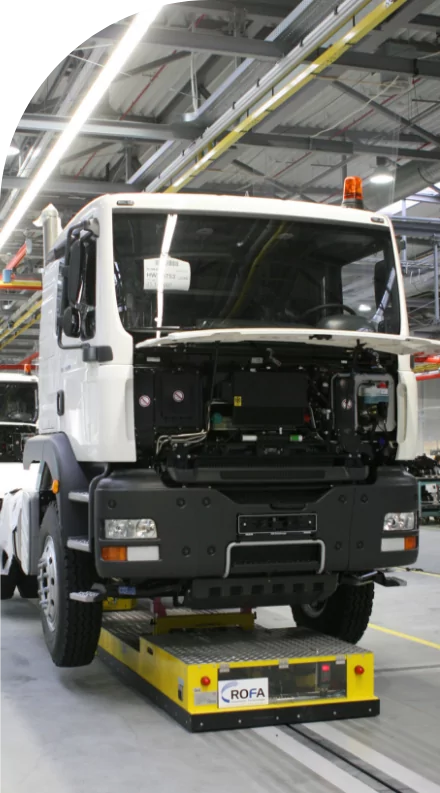 A white truck delivering high quality labels in a factory.